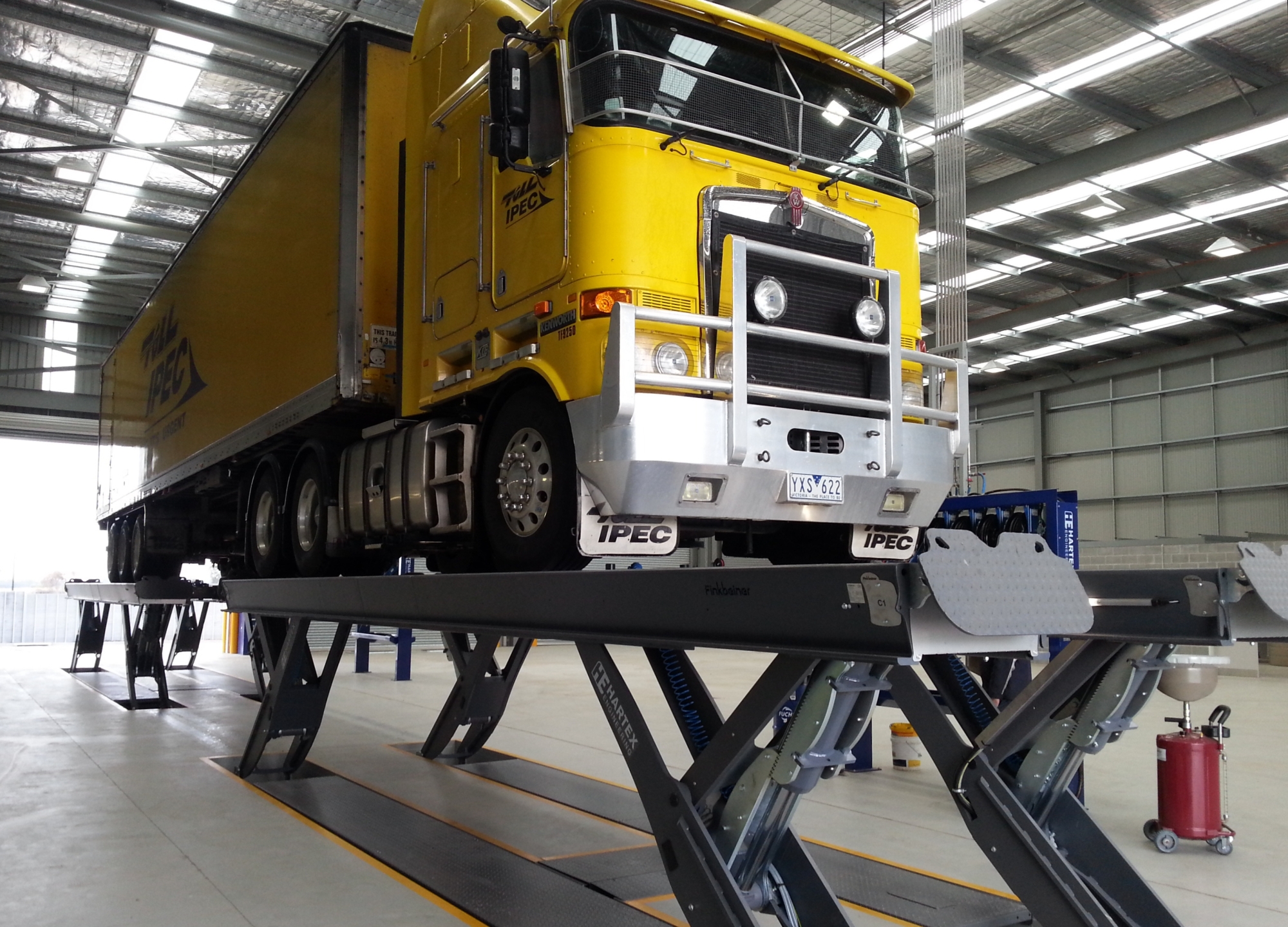Semi-scissor platform lift model HDS as a recessed lift with a road train on it.